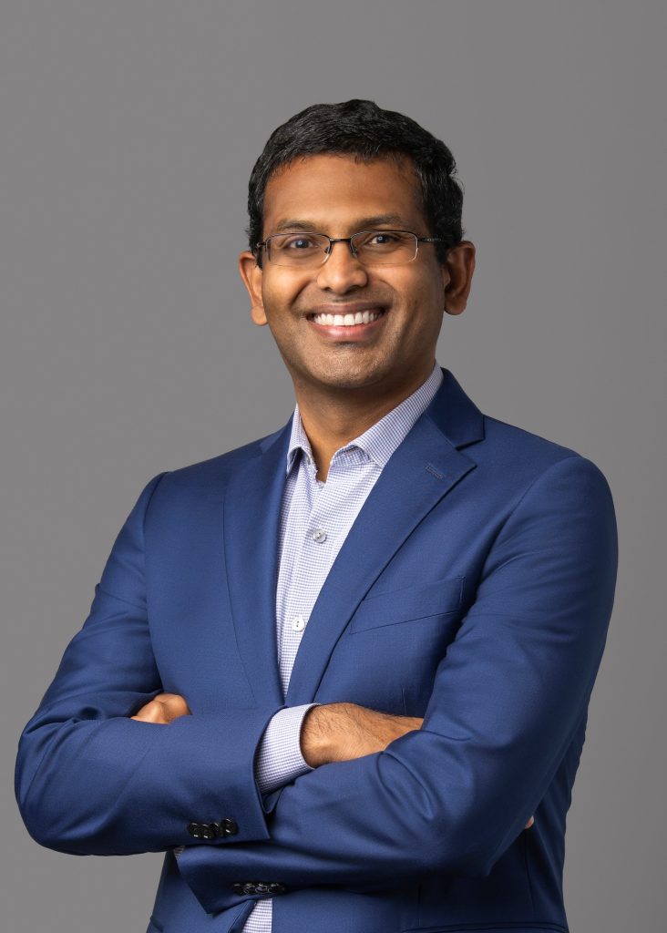 Rajesh in a blue suit.