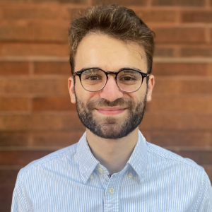 David, smiling, in a light blue shirt