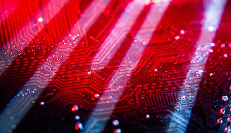 Close-up of motherboard circuits in red. 